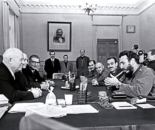Fidel Castro lighting a cigar and wearing two Rolex watches during a meeting with Khrushchev Kremlin 1963small